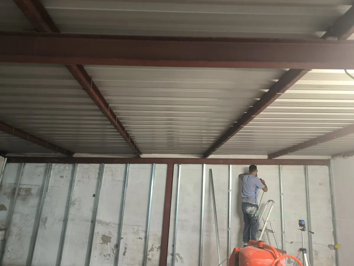 Fitting the metal framing for plasterboard walls