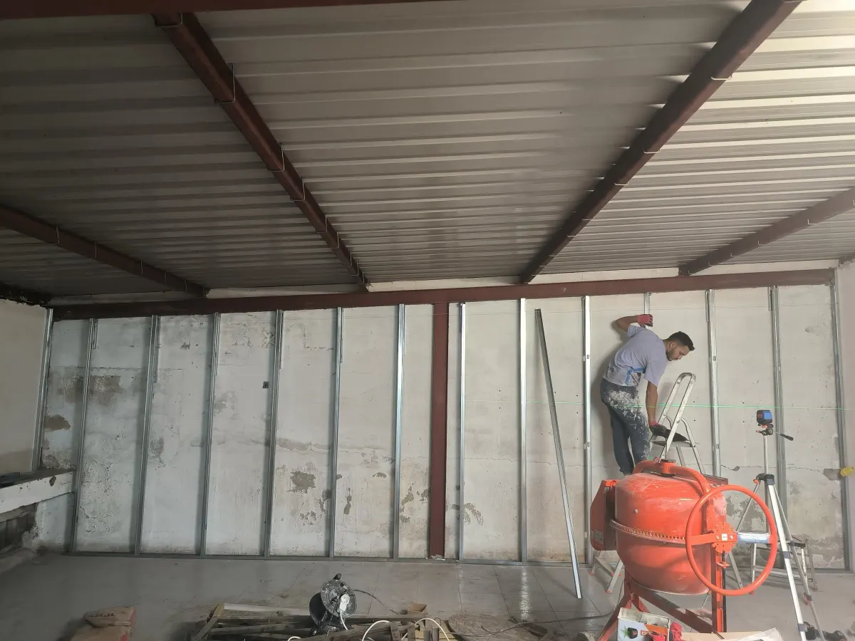 Worker fitting metal studs in the warehouse