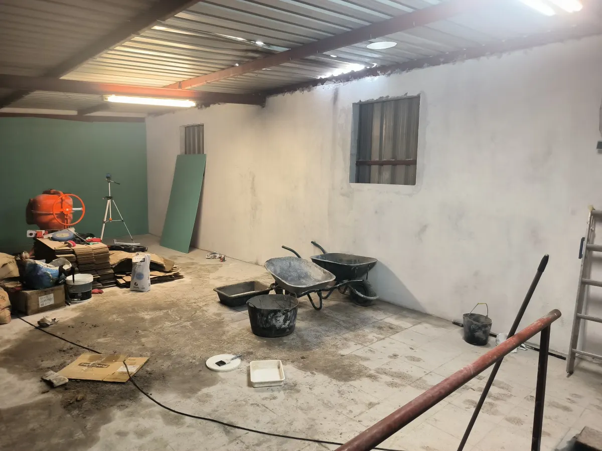 Warehouse during the works, with plasterboard fitted and materials on site